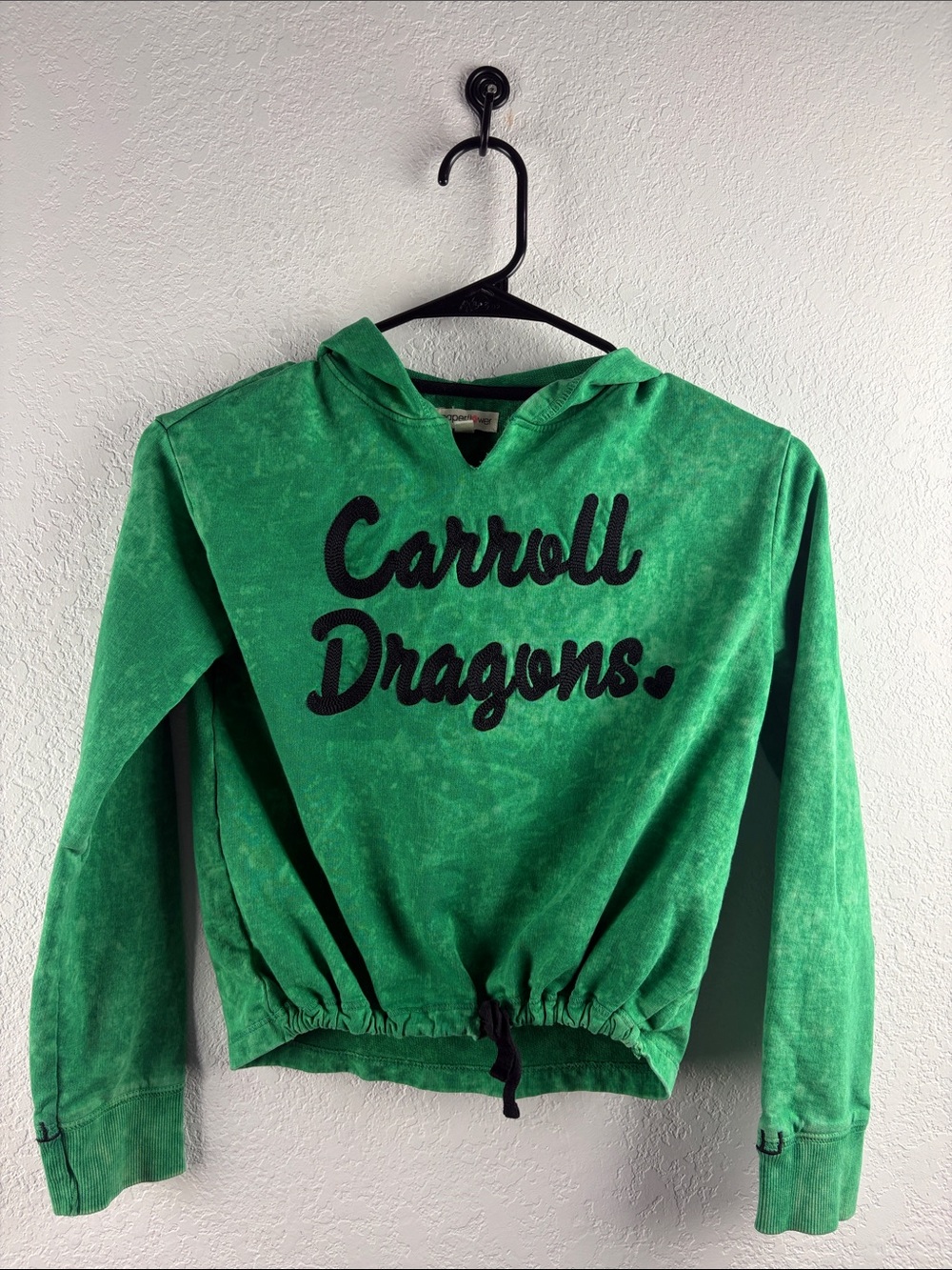 Paper Flower Green Carroll Dragons cropped hoodie with a cinched drawstring hem.